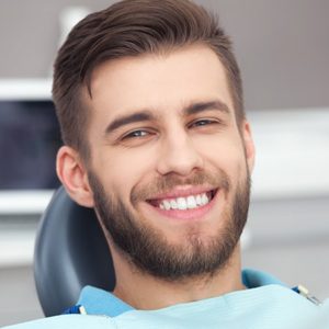 Bearded man smiles at the dentist's office